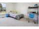 Bright room featuring a bed, desk, and view of the neighborhood at 6991 S Lee Way, Littleton, CO 80127