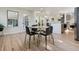 A modern dining room with fireplace adjacent to an open floor plan and kitchen at 6991 S Lee Way, Littleton, CO 80127