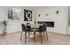 A modern dining room with fireplace, stylish decor, and bright natural light at 6991 S Lee Way, Littleton, CO 80127
