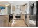 Charming kitchen with stainless steel appliances, light wood cabinets, and modern countertops at 6991 S Lee Way, Littleton, CO 80127