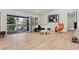 Living room with hardwood floors that open to a deck at 6991 S Lee Way, Littleton, CO 80127