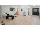 Spacious living room with hardwood floors, modern decor, and plenty of natural light at 6991 S Lee Way, Littleton, CO 80127