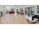 Open floorplan with hardwood floors that connects the kitchen, living, and dining areas at 6991 S Lee Way, Littleton, CO 80127