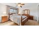 Bedroom with a wooden bed frame, matching furniture, and a ceiling fan at 10596 Ura Ln, Northglenn, CO 80234