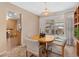 Cozy dining area featuring a wooden table set, slider and access to the kitchen and living room at 10596 Ura Ln, Northglenn, CO 80234