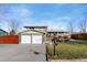 Two-car garage and well-manicured lawn at 10596 Ura Ln, Northglenn, CO 80234