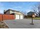 Two-car garage with a long driveway at 10596 Ura Ln, Northglenn, CO 80234