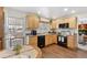 Functional kitchen with wood cabinets, black appliances, eat in table and a view to the back patio at 10596 Ura Ln, Northglenn, CO 80234