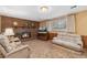 Cozy living room with a brick fireplace, mantle and a comfortable seating area at 10596 Ura Ln, Northglenn, CO 80234