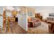 Warm living room with a traditional design, featuring a comfortable leather sofa, wood floors and adjacent kitchen at 10596 Ura Ln, Northglenn, CO 80234