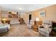 Inviting living room with wood paneled walls, neutral furniture and a staircase at 10596 Ura Ln, Northglenn, CO 80234