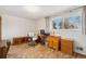 Office space with built-in shelves, a wooden desk, and a rolling chair at 10596 Ura Ln, Northglenn, CO 80234