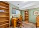 Home office featuring built-in shelves, a wooden desk, and a rolling chair at 10596 Ura Ln, Northglenn, CO 80234