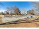 A view of Sperry Park's basketball court and playground with mature trees at 10596 Ura Ln, Northglenn, CO 80234