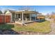 Covered patio area with outdoor seating and dining, perfect for relaxation at 10596 Ura Ln, Northglenn, CO 80234