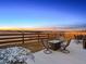 Scenic backyard with a fire pit, seating, and a privacy fence, offering a perfect space for outdoor entertaining at 55 S Edge Cliff St, Castle Rock, CO 80104