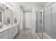 Bright bathroom featuring double vanity, sleek shower, and modern fixtures at 55 S Edge Cliff St, Castle Rock, CO 80104
