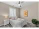 Comfortable bedroom with neutral decor, a ceiling fan, a nightstand, and natural light from the window at 55 S Edge Cliff St, Castle Rock, CO 80104