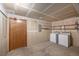 A basement featuring a washer, dryer and ample shelving units at 8753 W Cornell Ave # 12-1, Denver, CO 80227