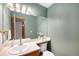 Cozy bathroom with a classic vanity, a large mirror, and soft lighting at 8753 W Cornell Ave # 12-1, Denver, CO 80227