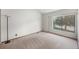 Carpeted bedroom with a large window providing natural light and exterior views at 8753 W Cornell Ave # 12-1, Denver, CO 80227