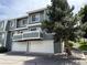 Two-story townhome boasts attached garages, balconies, and mature trees in an inviting community at 8753 W Cornell Ave # 12-1, Denver, CO 80227