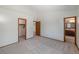 A spacious main bedroom featuring neutral walls, carpeted floors, and ensuite access at 8753 W Cornell Ave # 12-1, Denver, CO 80227