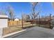 Spacious backyard with a concrete patio, grassy area, and mature trees at 1655 S Quintero Way, Aurora, CO 80017