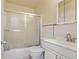 Clean bathroom featuring a shower-tub combo with sliding glass doors and a classic sink at 1655 S Quintero Way, Aurora, CO 80017