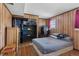 Cozy bedroom with a comfortable bed, wood paneling, and plenty of closet space at 1655 S Quintero Way, Aurora, CO 80017