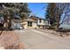 Front view of a charming residence with a two-car garage and a meticulously maintained driveway at 1655 S Quintero Way, Aurora, CO 80017