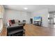 A well-lit living room with hardwood floors and a comfortable sectional sofa at 1655 S Quintero Way, Aurora, CO 80017