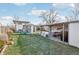 Spacious backyard with grassy area, playset, and patio at 6721 Birch St, Commerce City, CO 80022