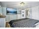 Main bedroom with large TV and access to bathroom at 6721 Birch St, Commerce City, CO 80022