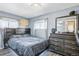 Bedroom with a bed, dresser, and dark wood furniture at 6721 Birch St, Commerce City, CO 80022