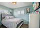 Light blue bedroom with a queen bed and dresser at 6721 Birch St, Commerce City, CO 80022