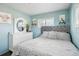 Bedroom with a queen bed, dresser, and light blue walls at 6721 Birch St, Commerce City, CO 80022