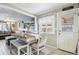 Farmhouse style dining area with white table and chairs at 6721 Birch St, Commerce City, CO 80022