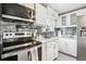 Kitchen with stainless steel appliances and gray backsplash at 6721 Birch St, Commerce City, CO 80022