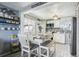 Bright kitchen with white cabinets and farmhouse table at 6721 Birch St, Commerce City, CO 80022