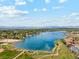 Scenic aerial view of a tranquil lake surrounded by lush greenery and charming homes nestled in a beautiful landscape at 3595 W 67Th S Ave, Denver, CO 80221