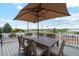 Outdoor dining set with umbrella on a spacious, covered balcony with lake views at 3595 W 67Th S Ave, Denver, CO 80221