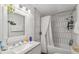 Well-lit bathroom with a modern vanity, decorative mirror, and shower-tub combination at 3595 W 67Th S Ave, Denver, CO 80221