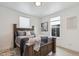 Stylish bedroom with a wooden bed frame, modern decor, and plenty of natural light at 3595 W 67Th S Ave, Denver, CO 80221