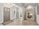Open foyer with hardwood floors, a decorative mirror, and a glimpse of the bedroom at 3595 W 67Th S Ave, Denver, CO 80221