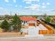 Aerial view of a charming home with a red roof, modern garage door, and a well-manicured front yard at 3595 W 67Th S Ave, Denver, CO 80221