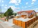 Aerial view of a well-maintained home with a red roof, modern garage door, and landscaped front yard at 3595 W 67Th S Ave, Denver, CO 80221