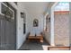 Cozy front porch with seating, plants, and charming decor elements at 3595 W 67Th S Ave, Denver, CO 80221
