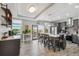 Modern kitchen features a large island with seating, stainless steel appliances, and sliding door access to the deck at 3595 W 67Th S Ave, Denver, CO 80221