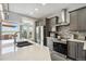 Modern kitchen boasts stainless appliances, granite countertops and a door leading to an outdoor deck area at 3595 W 67Th S Ave, Denver, CO 80221